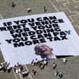 A giant sheet on the ground reading “If you can rent Venice for your wedding you can pay more tax”
