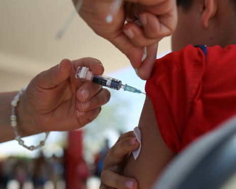 A vaccine needle and a child's arm